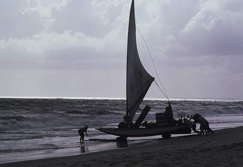 Roladores and jangadeiros pushing a jangada to the water