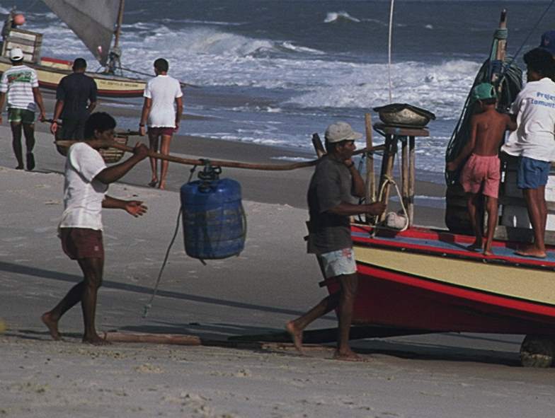 Two men carrying a jangada's Barril or water cask.