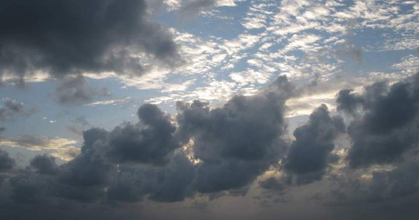 Sky with sun filtering through clouds.