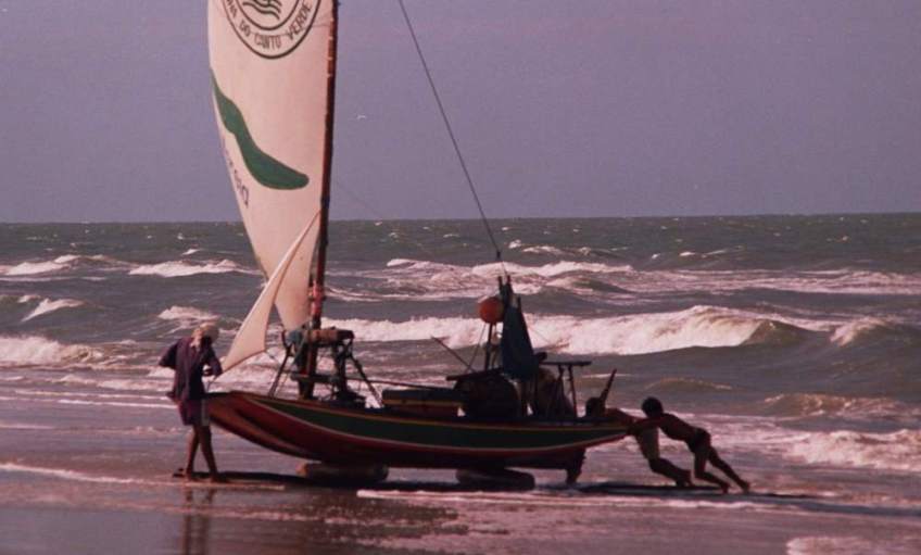 Pushing a jangada back up the beach